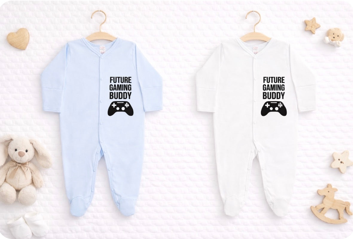 White or blue baby onesie with 'Future Gaming Buddy' text and game controller graphic on a white background