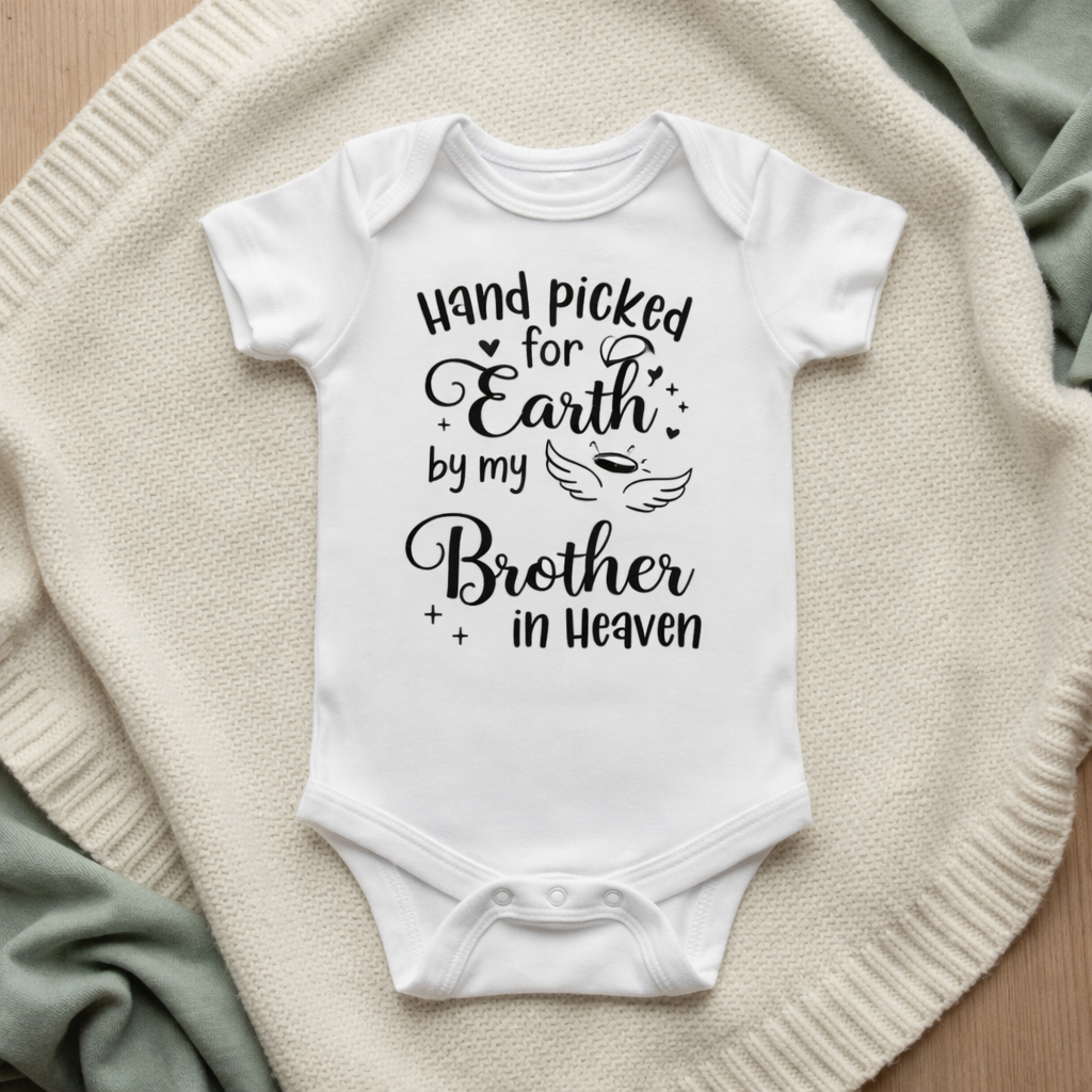 White baby onesie with text on a textured surface Handpicked for Earth by my Brother in Heaven Baby Bodysuit
