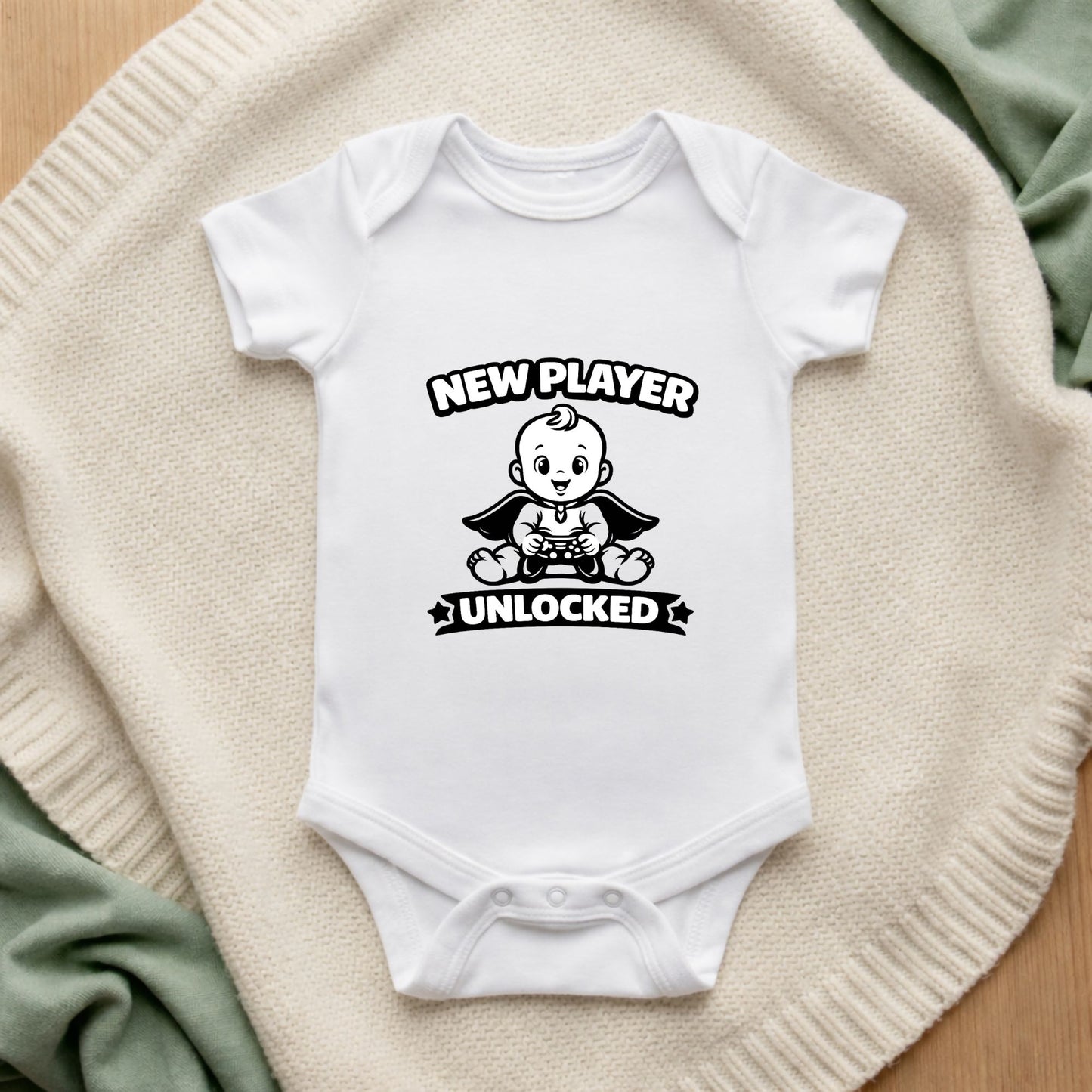White baby onesie with graphic design and text on a textured surface New Player Unlocked Baby Vest