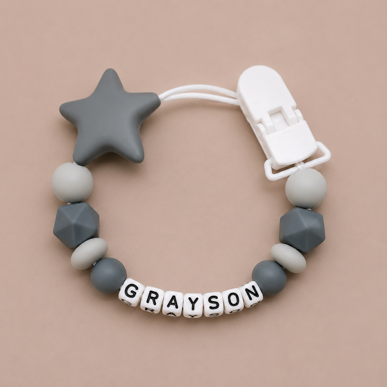 dummy clip with star and geometric beads on a beige background