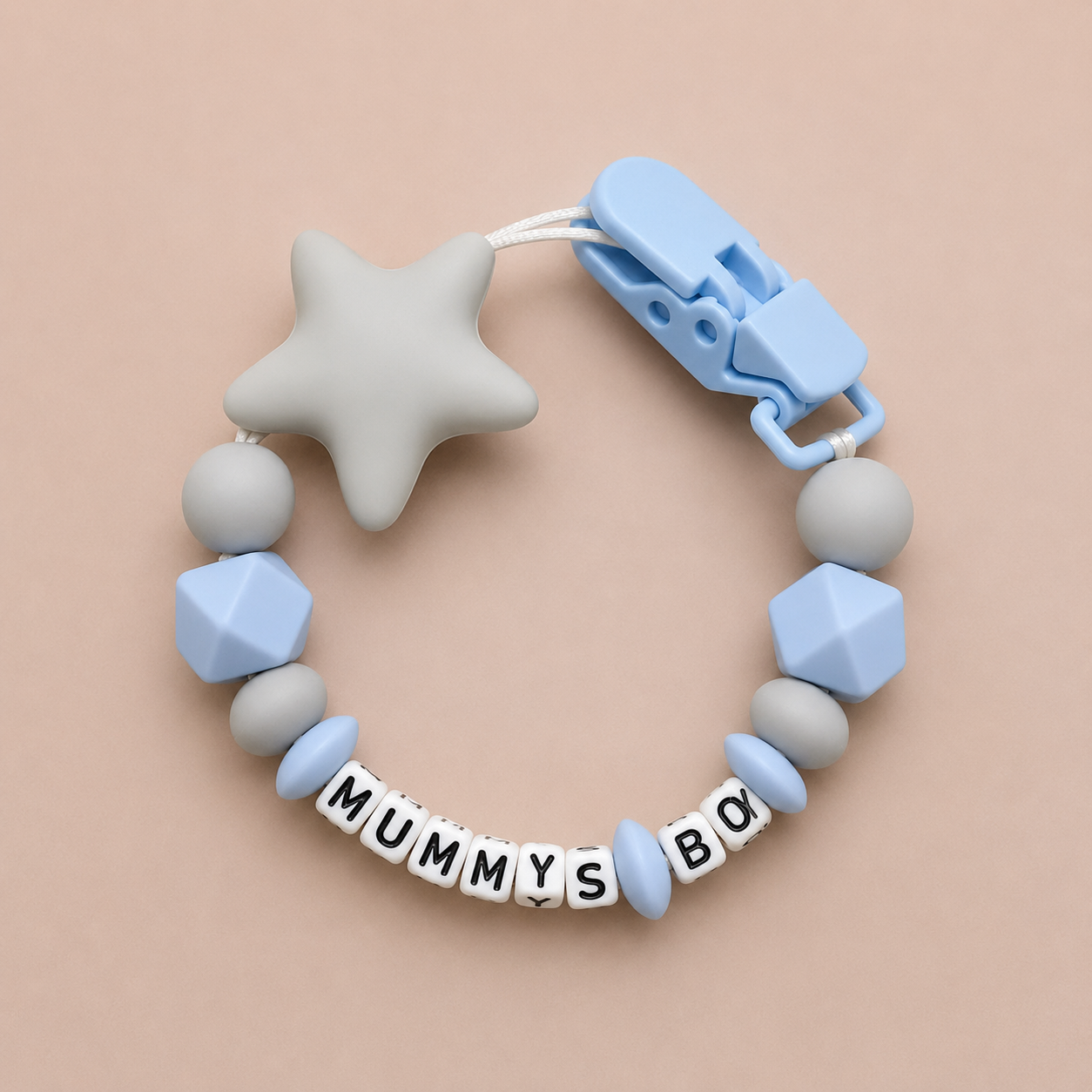 Baby dummy clip with geometric beads and star-shaped chewable on a beige background