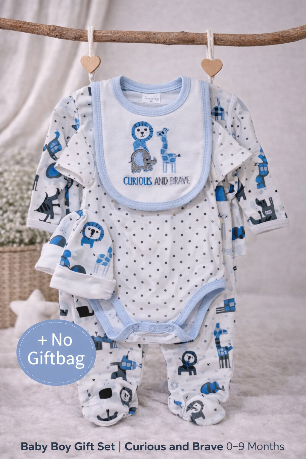 Baby boy gift set with clothes and bib hanging on a branch