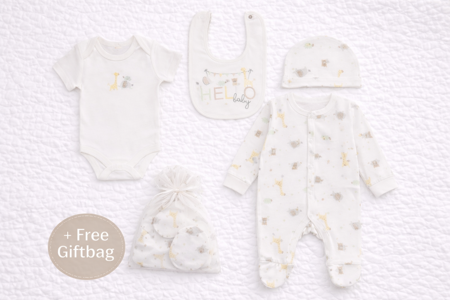 Baby clothing set with onesie, bib, and booties on a textured white background