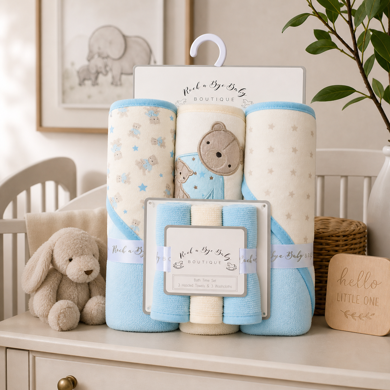 Baby blankets and plush toy set on a dresser with 'Rock a Bye Baby' branding.