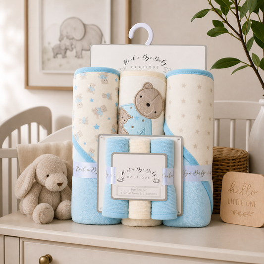 Baby blankets and plush toy set on a dresser with 'Rock a Bye Baby' branding.