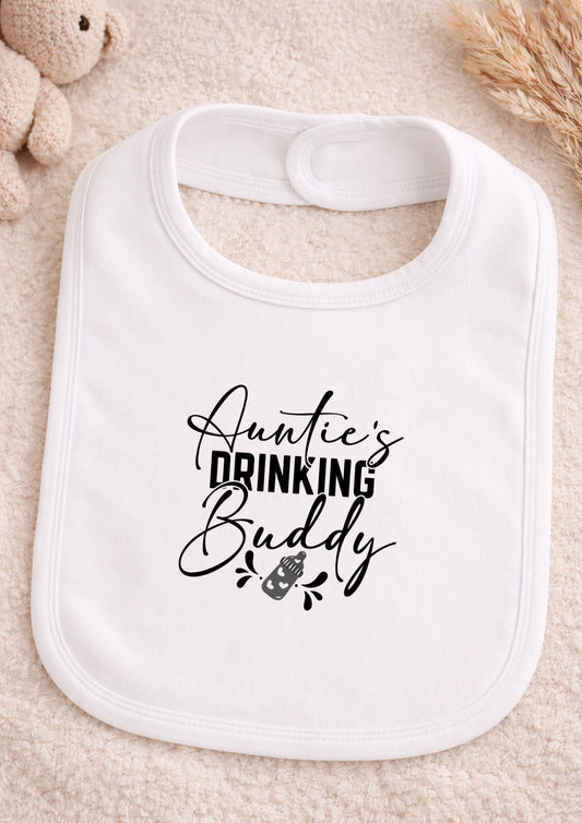 White bib with 'Auntie's Drinking Buddy' text on a beige surface