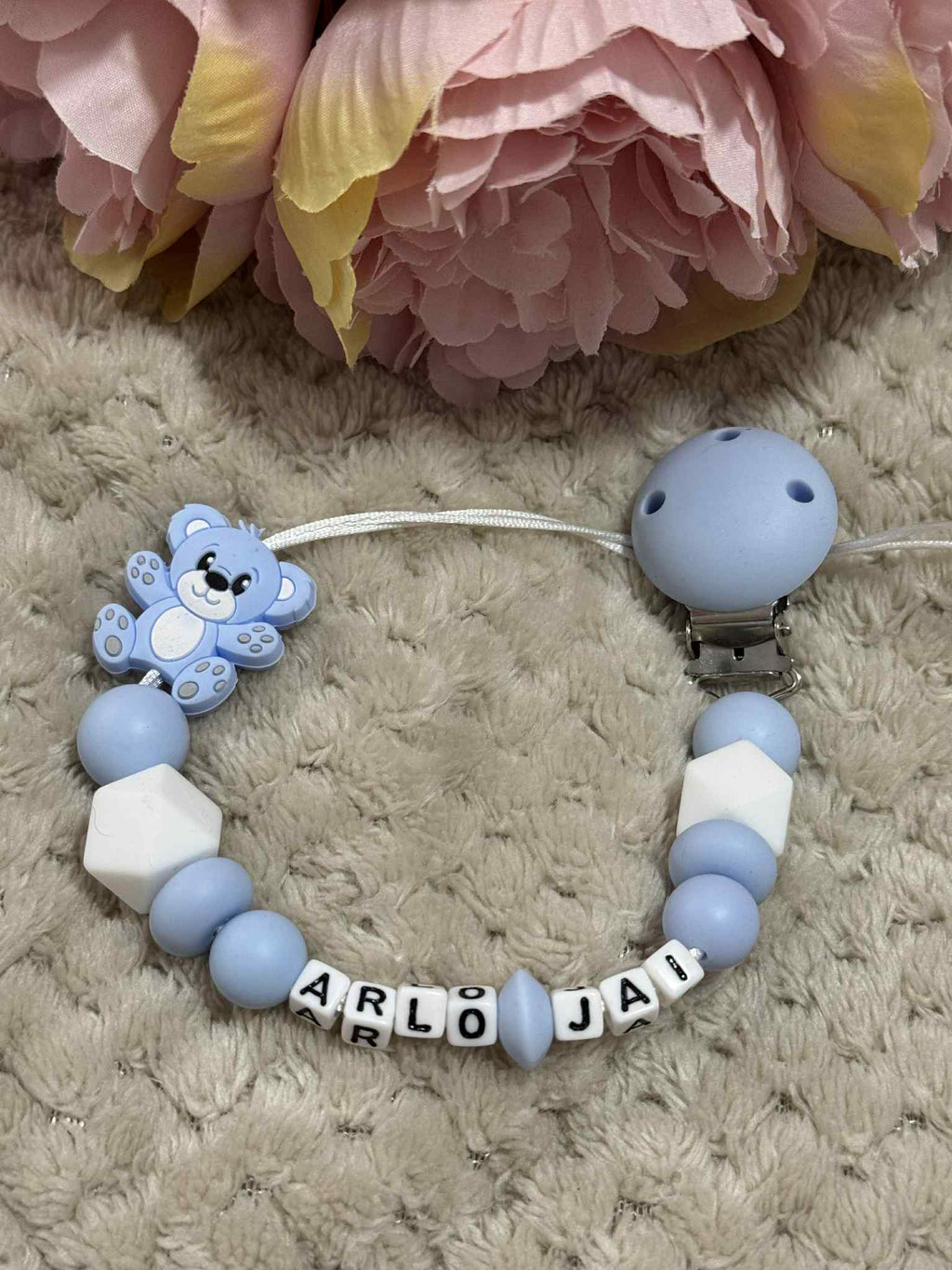 Blue and white teddybear dummy chain on a beige textured surface personalised with the name 'Arlo-Jai'. Personalisation and MAM Adapter options available.