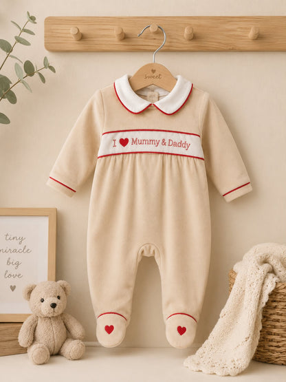 Cream velour baby sleepsuit with I Love Mummy and Daddy embroidery, Peter Pan collar and red heart detail on hanger