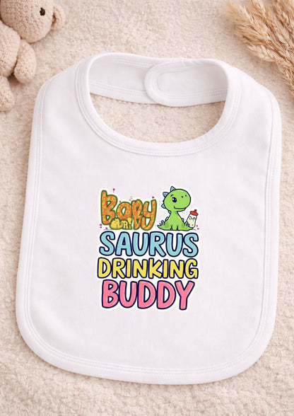 White bib with colorful text and dinosaur graphic on a beige surface