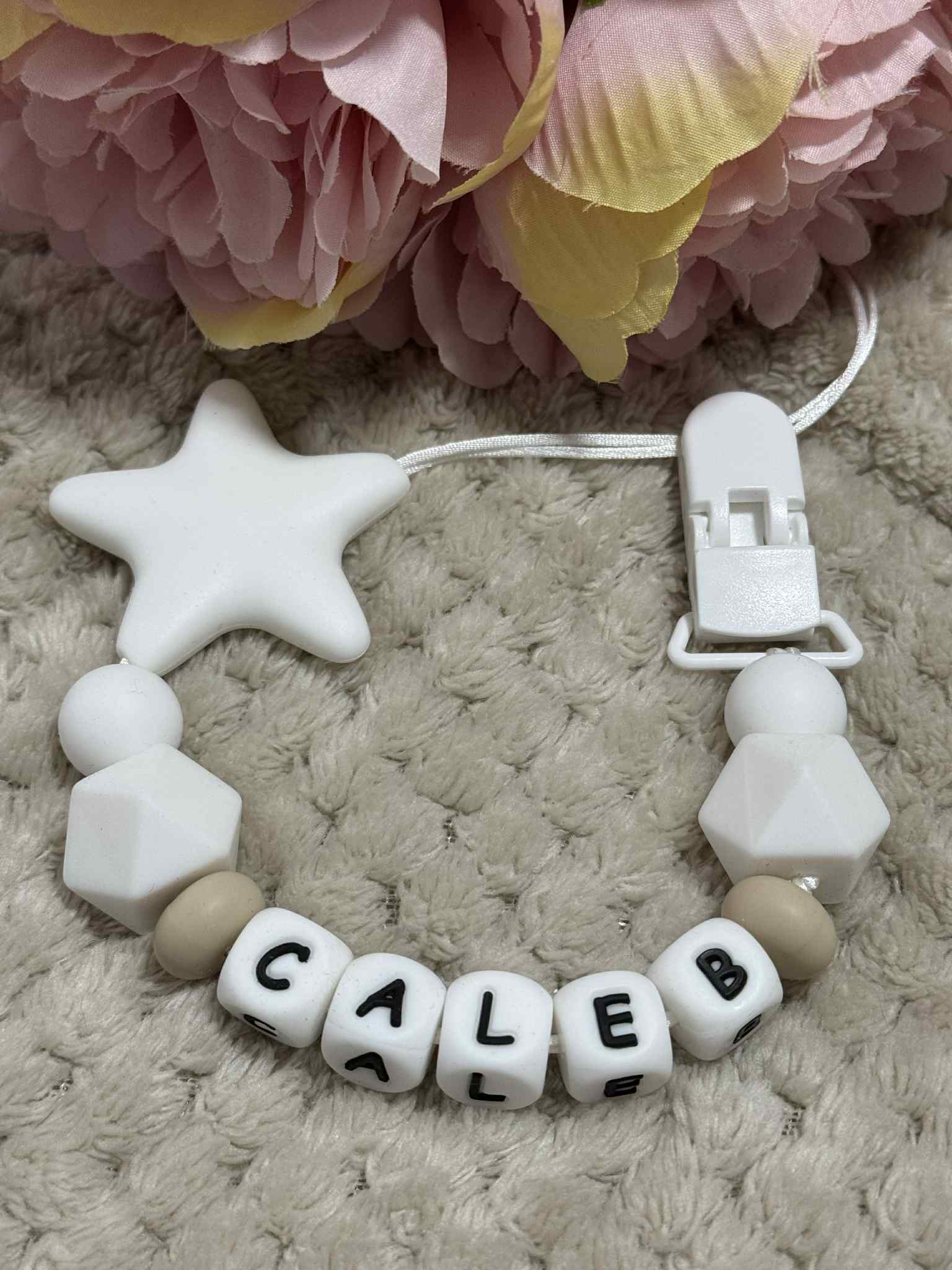 A dummy clip in Beige and white colors, personalized with any name 