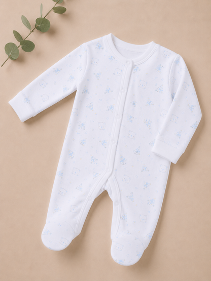 White baby onesie with blue patterns on a beige background