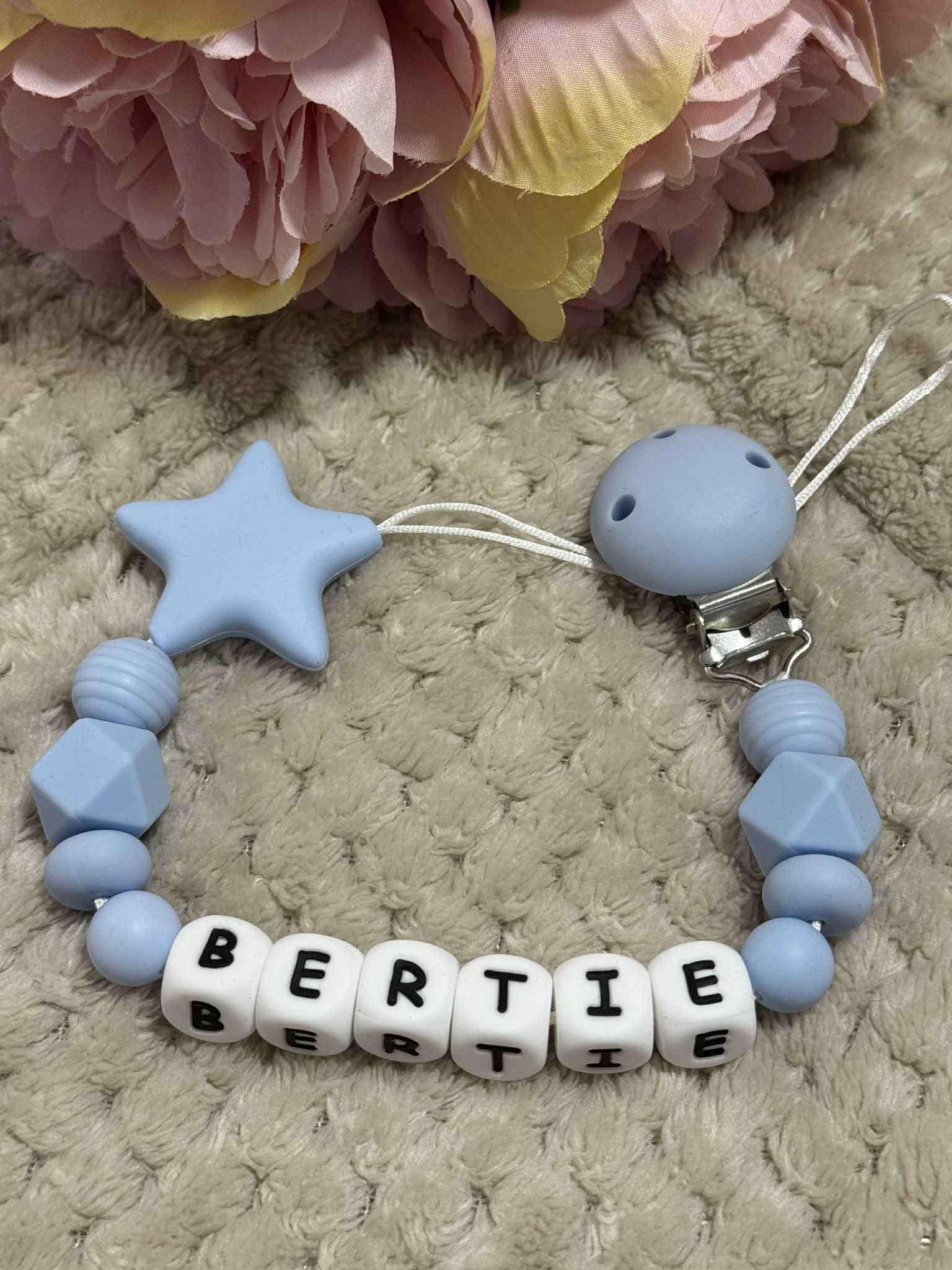 A dummy clip in blue and white colors, personalized with any name 