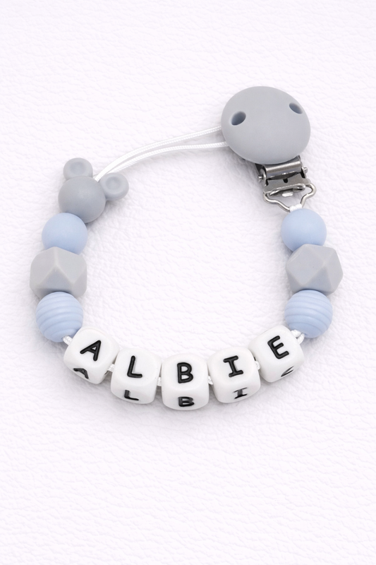 Baby dummy clip with 'ALBIE' on a white background