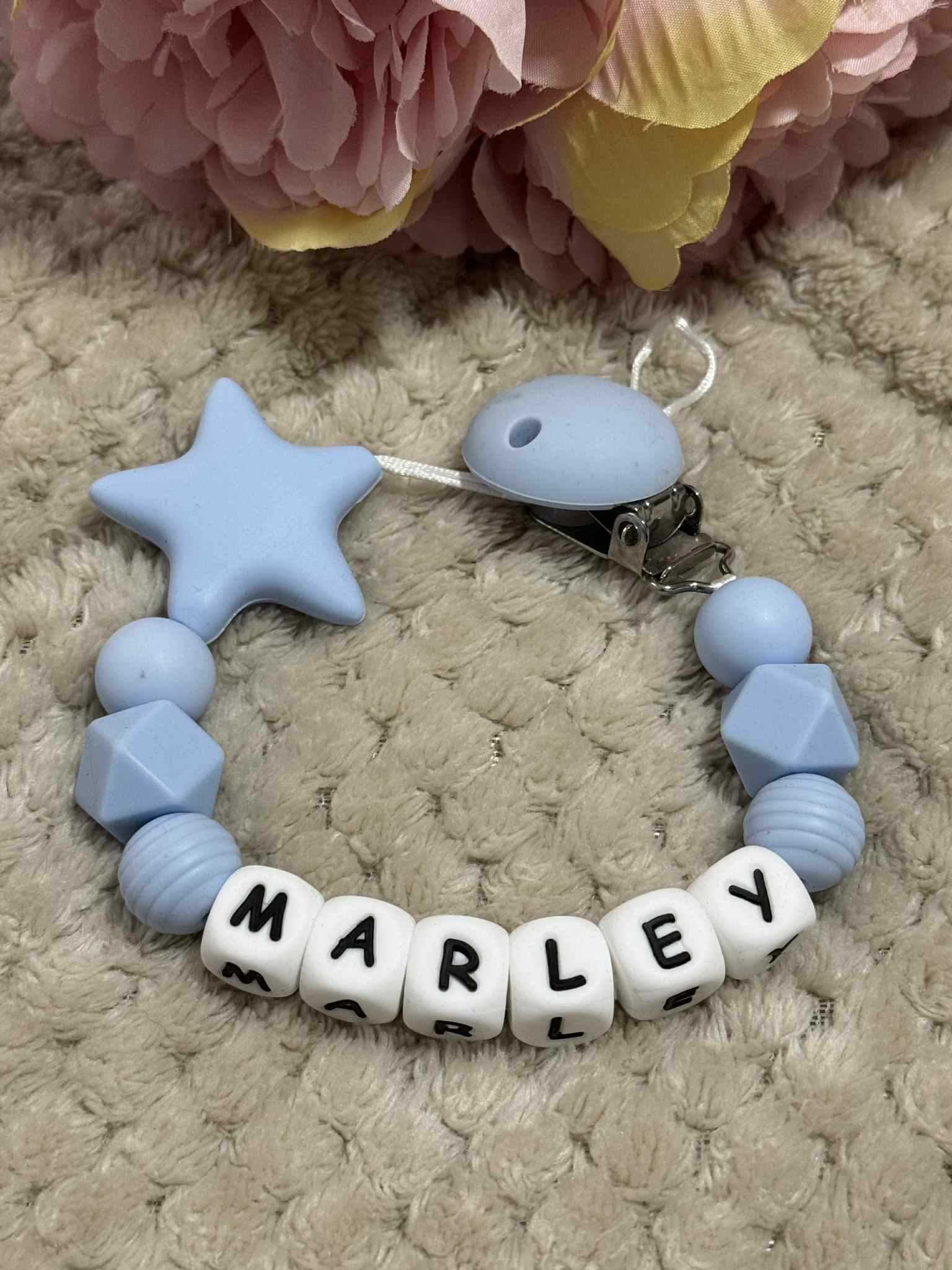 A dummy clip in blue and white colors, personalized with any name 