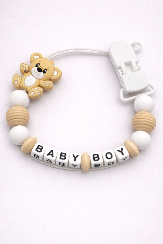 Baby dummy clip with 'BABY BOY' beads and teddy bear design on a white background