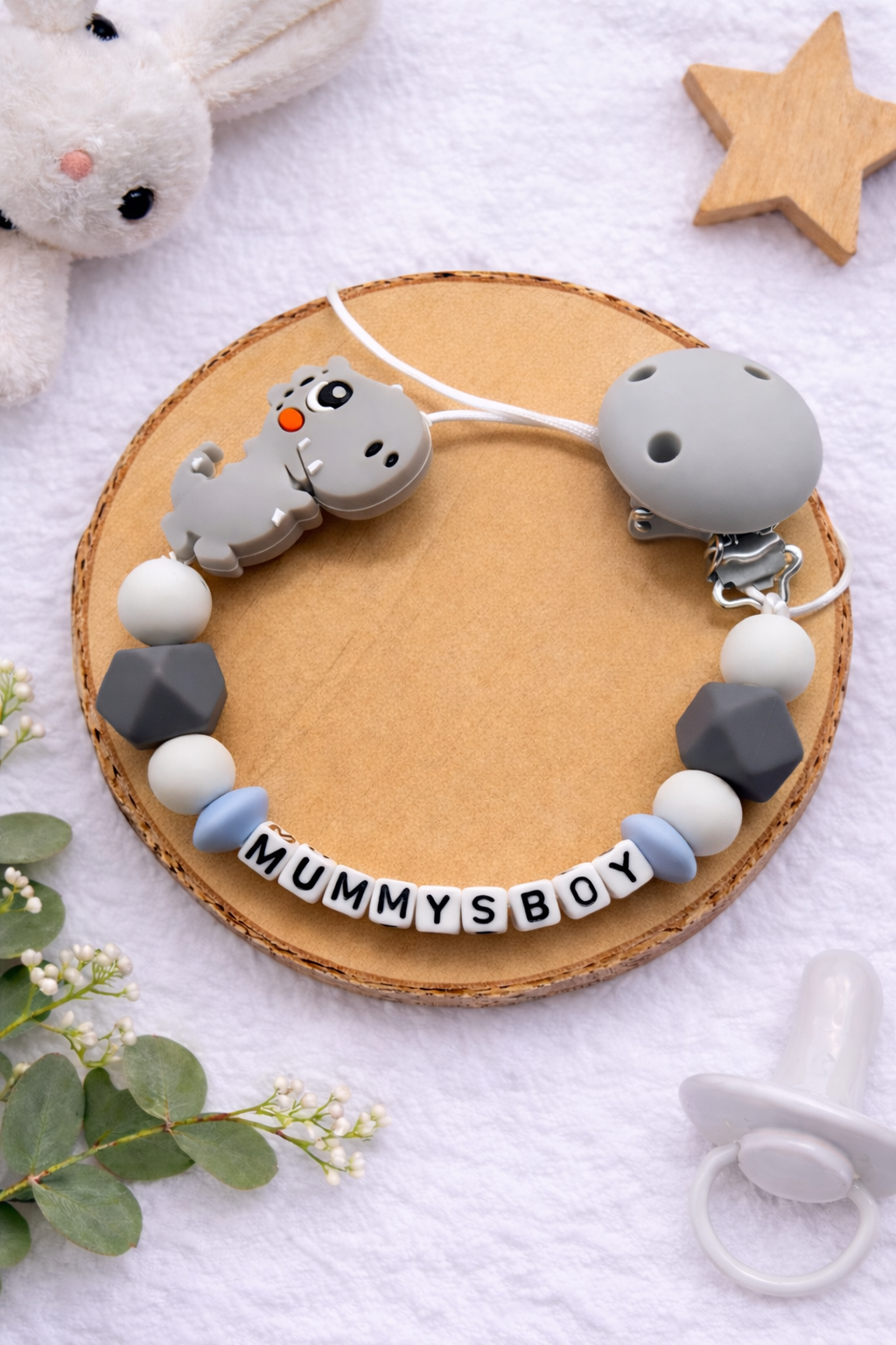 Dark grey personalised dummy clip featuring a dinosaur design for babies.