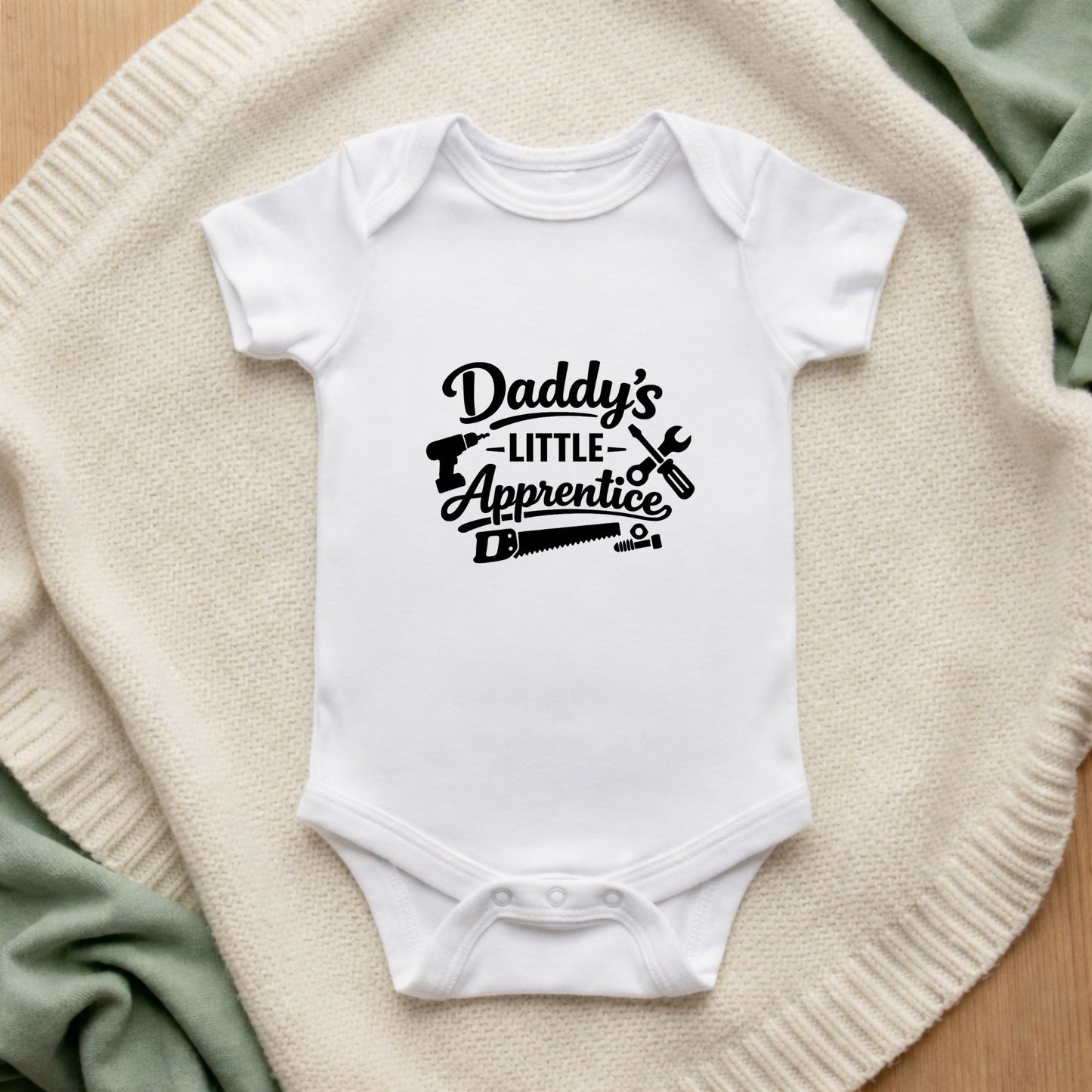 White baby onesie with  Daddy's Little Apprentice Baby Vest
