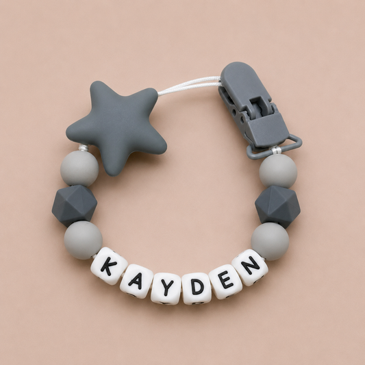 dummy clip with star and geometric beads on a beige background