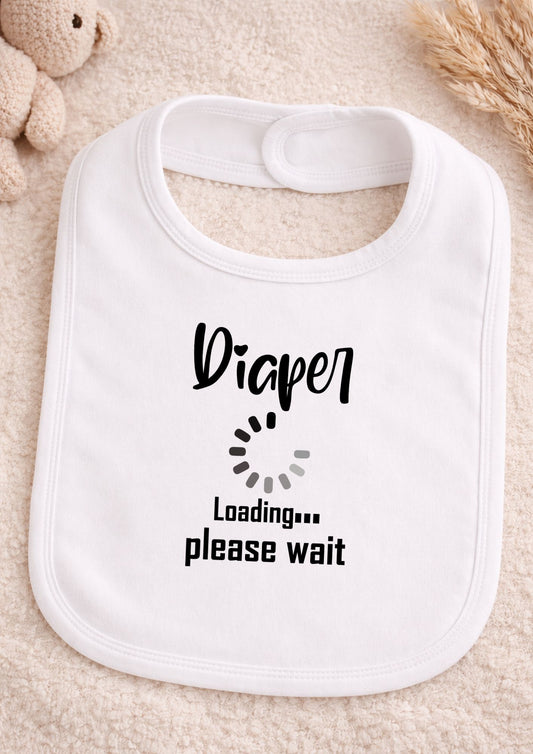 White bib with 'Diaper Loading... Please Wait' text on a soft beige background
