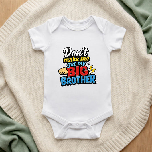 White baby onesie with colorful text on a textured surface Don't Make Me Get My Big Brother Baby Bodysuit