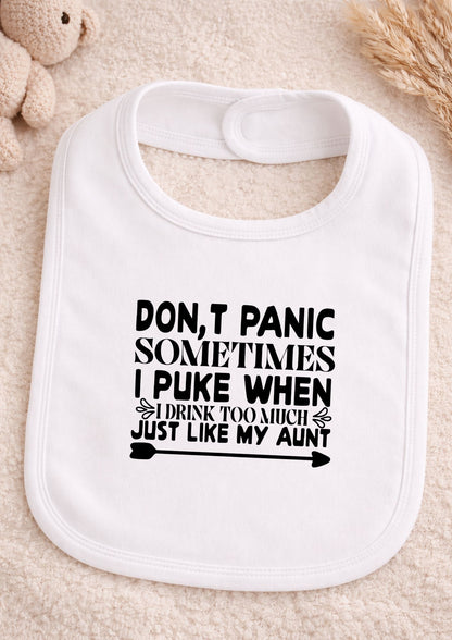 White baby bib with humorous text on a beige surface Don't Panic Sometimes I Puke Just Like My Aunt Baby Bib | Funny Newborn Gift