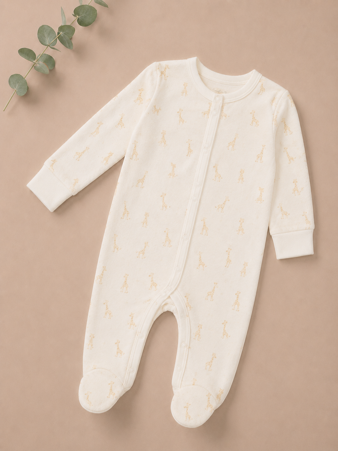 Baby onesie with a subtle pattern on a beige background