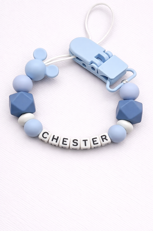 dummy clip with blue and white beads and a clip on a white background