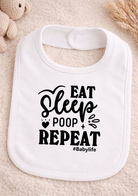 White baby bib with 'Eat Sleep Poop Repeat #Babylife' text on a beige background