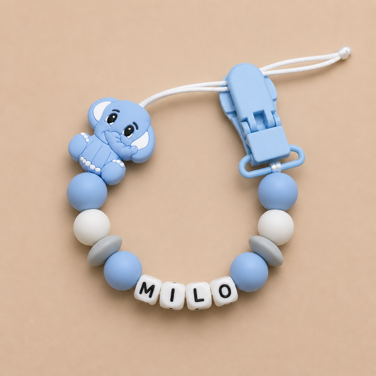 Silicone dummy clip with elephant design and 'MILO' label on a beige background