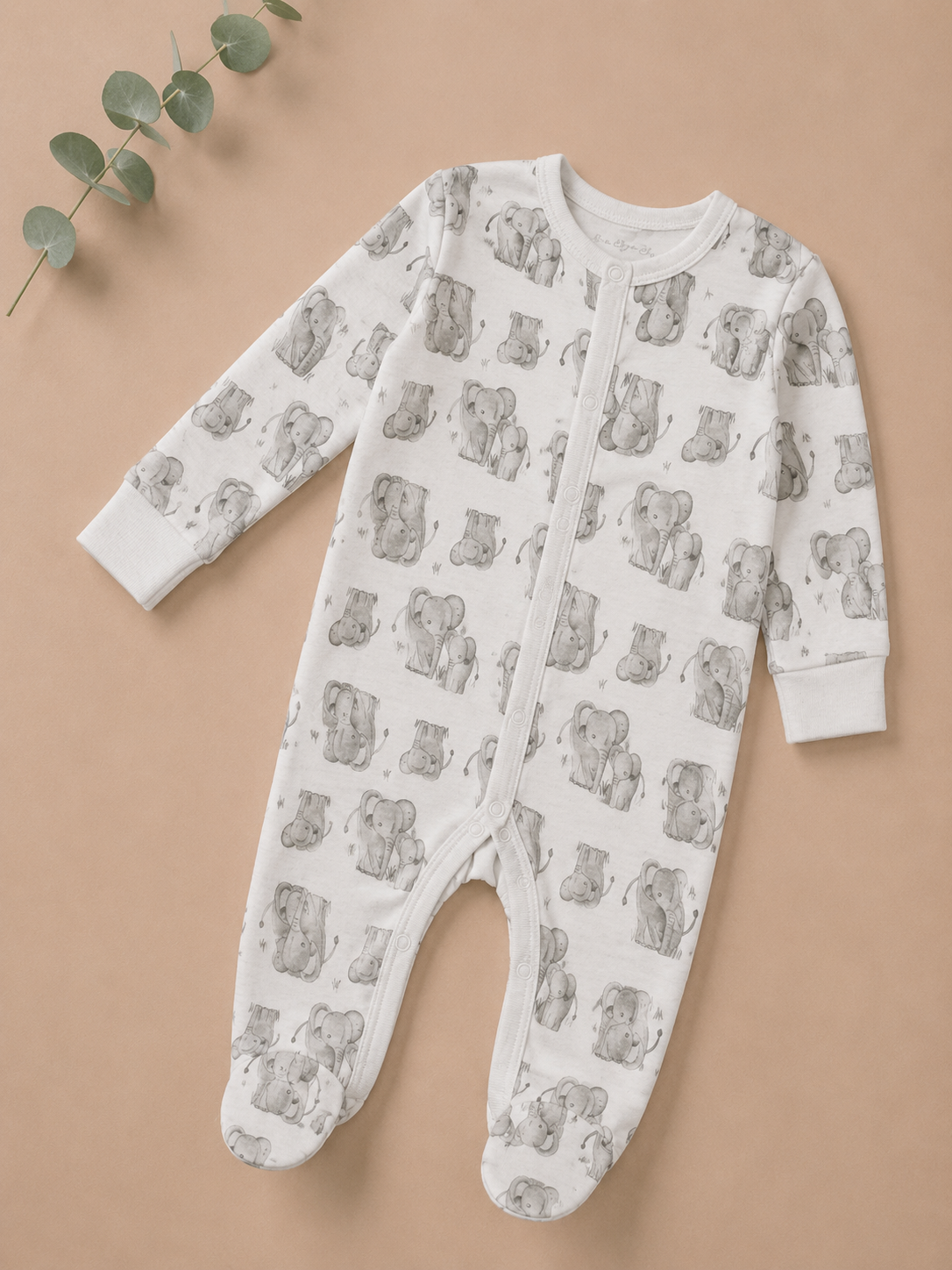 Baby onesie with bear pattern on a beige background