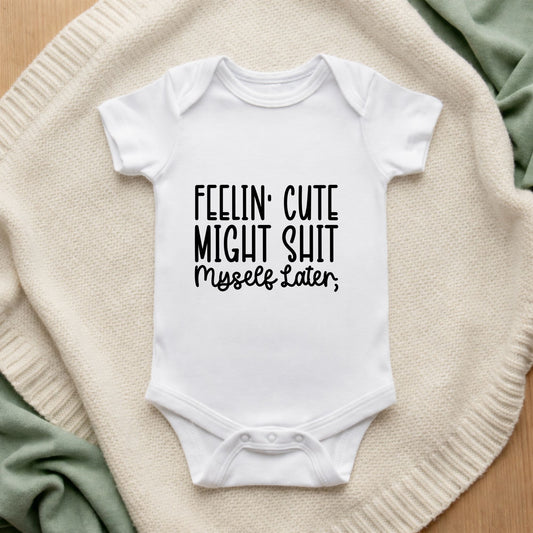 White baby onesie with humorous text on a textured surface Feelin' Cute Might Sh*t Myself Later Baby Bodysuit