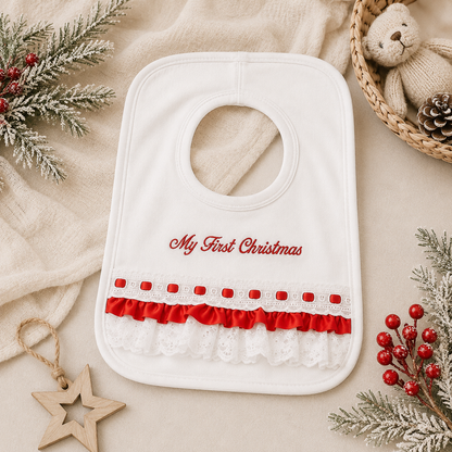 My First Christmas baby bib flat lay with red embroidery, satin and lace ruffle detail