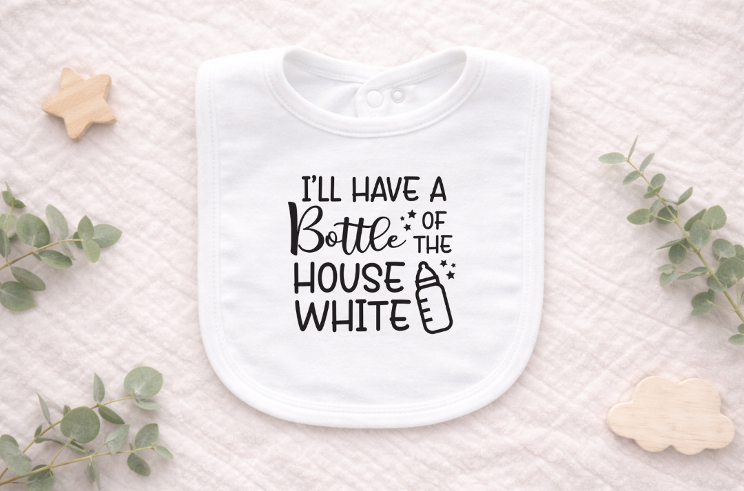 Cute newborn wearing a white baby bib featuring the phrase “I’ll Have a Bottle of the House White,” styled for feeding time and playful baby photos.