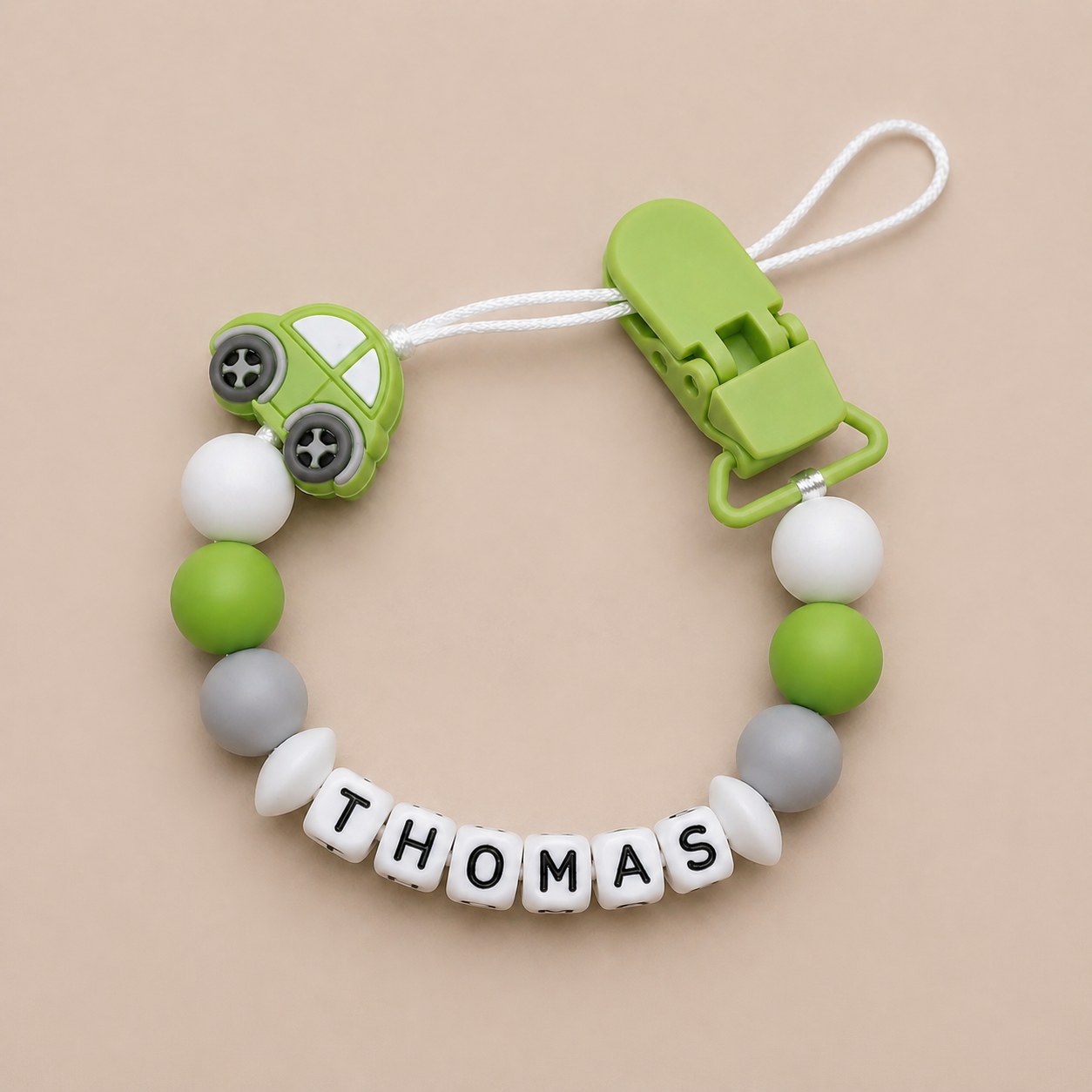 dummy clip with colorful beads and a clip on a beige background