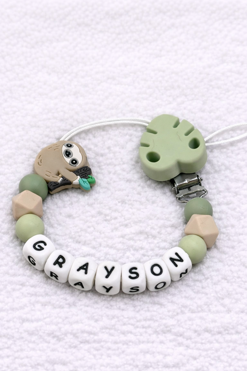Bracelet with letter beads spelling 'GRAYSON' on a white background