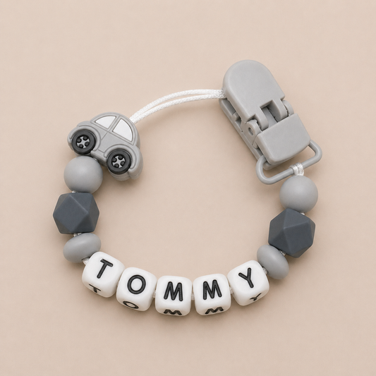 dummy clip with geometric beads and car-shaped clip on a beige background