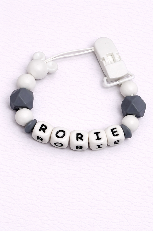 dummy clip with letter beads spelling 'Rorie' on a white background