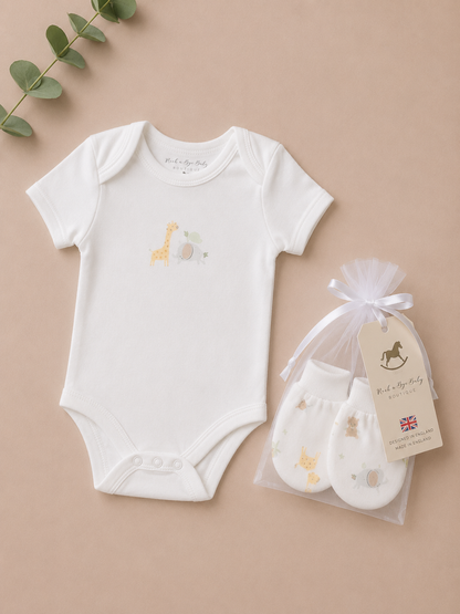 Baby onesie with embroidered design and matching socks on a beige background