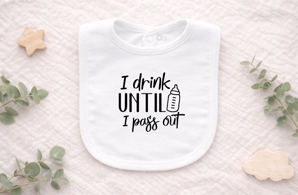 Flat lay of a funny newborn baby bib with playful drinking text.