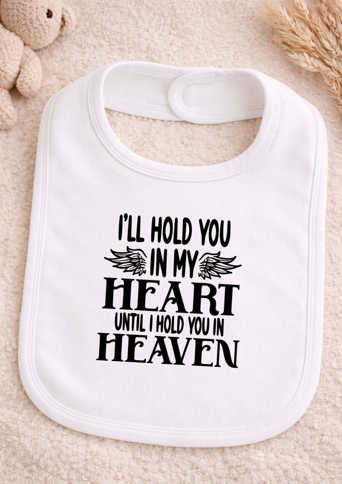 White bib with text on a beige background