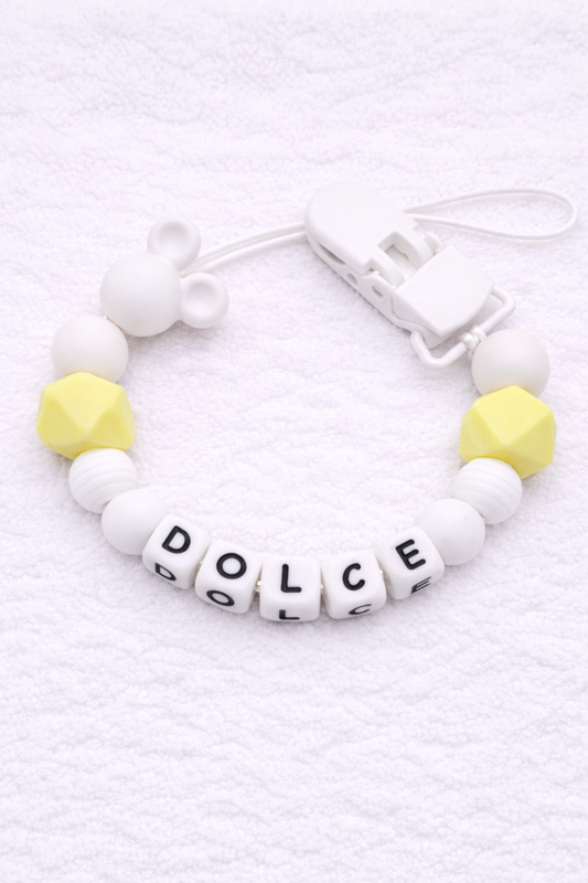 Dummy Clip with letter beads spelling 'DOLCE' on a white background
