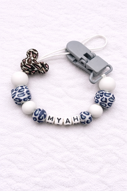 Dummy Clip with leopard print and white beads on a white background
