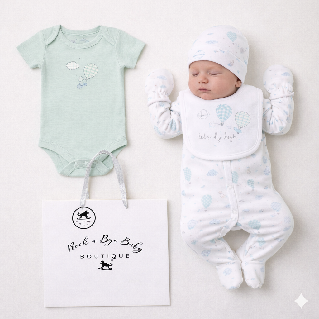 Baby outfit set with onesie, hat, and romper on a white background with 'Rock a Bye Baby Boutique' branding.