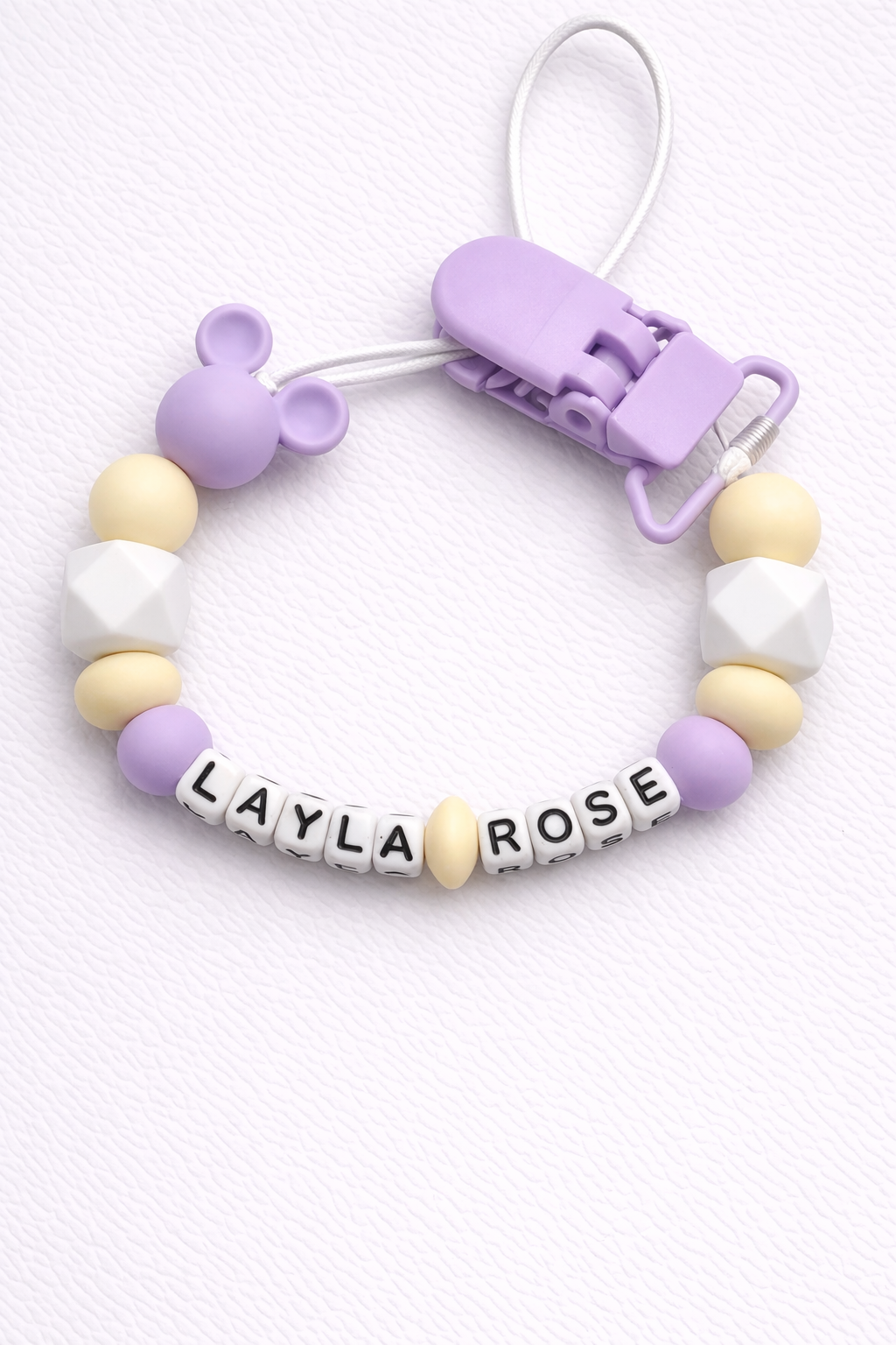 Baby dummy clip with colorful beads and 'LAYLA ROSE' branding on a white background