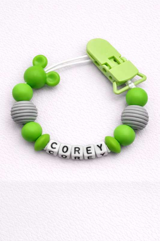 Green and gray dummy clip with a clip on a white background