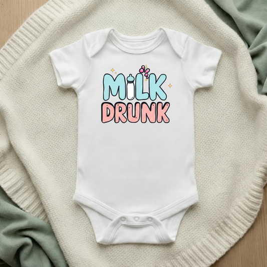 Milk Drunk baby bodysuit mockup flat lay on cream knit blanket