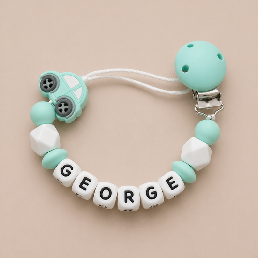 dummy clip with 'GEORGE' beads on a beige background
