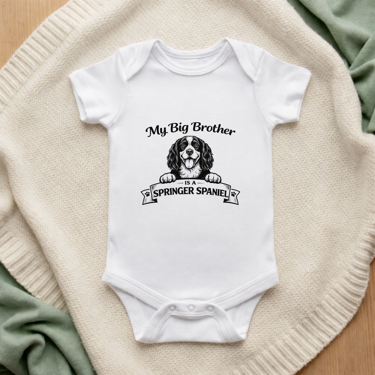 White baby onesie with a dog illustration and text on a textured surface My Big Brother is a Springer Spaniel Baby Bodysuit