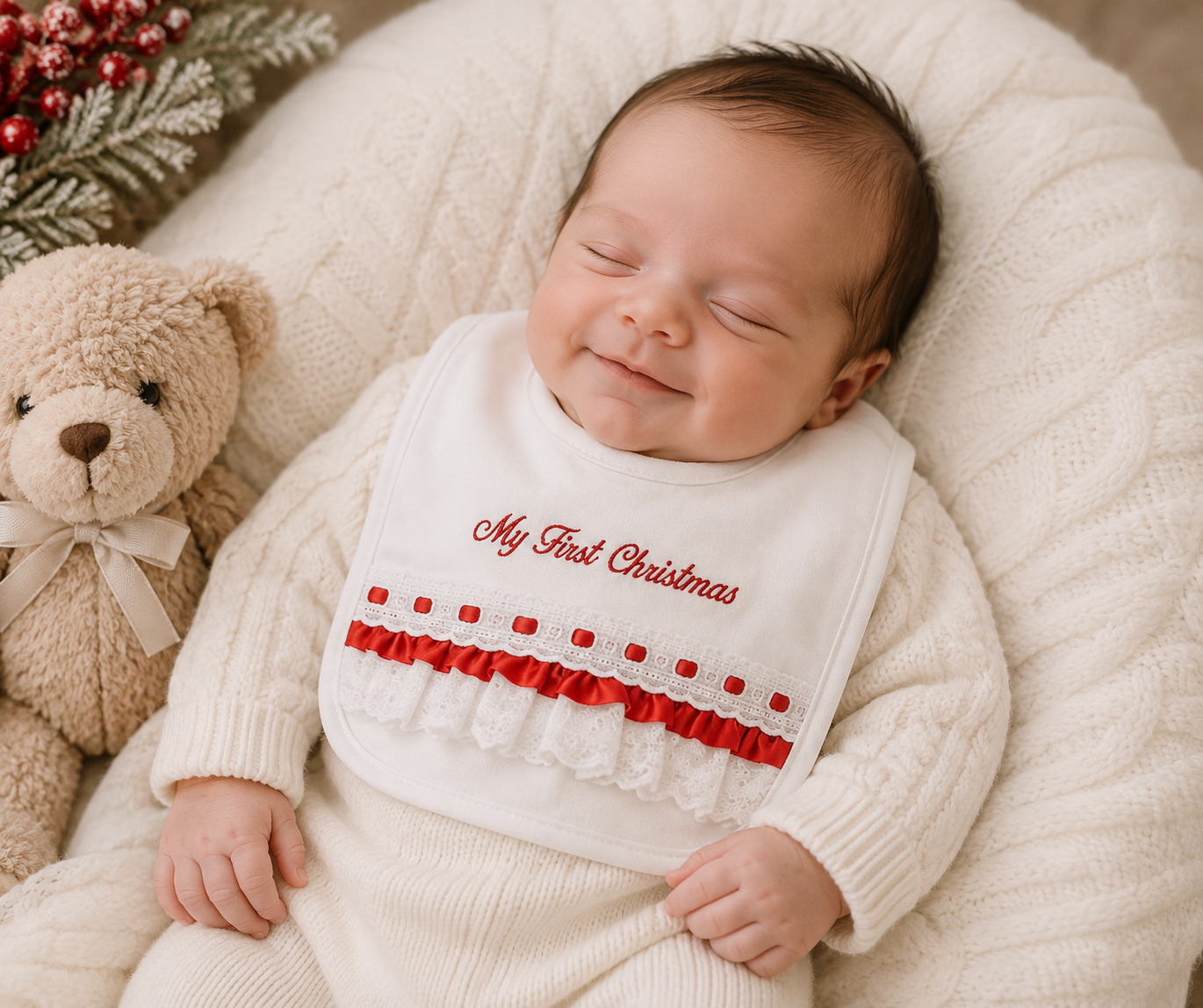 Baby wearing My First Christmas bib with red embroidery and lace ruffle trim