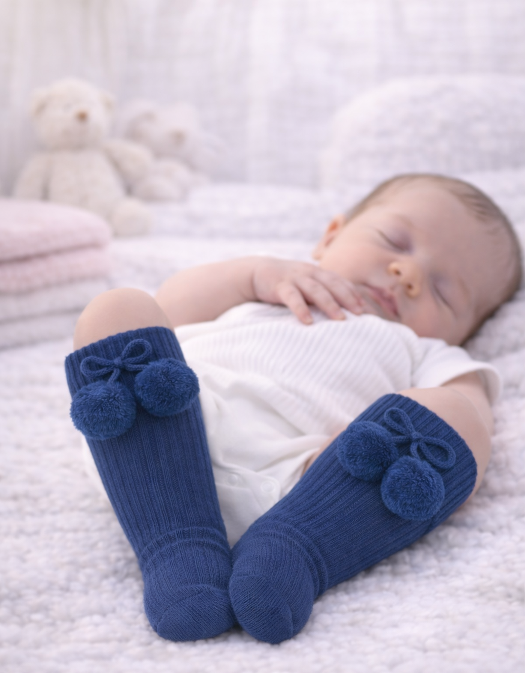 These navy infant pom-pom knee-high socks are designed to keep tiny legs warm while adding a sweet finishing touch to any outfit.